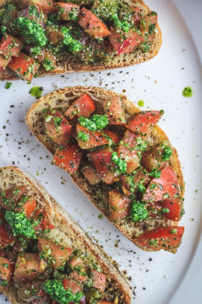 3 slices of bruschetta with tomatoes and pesto