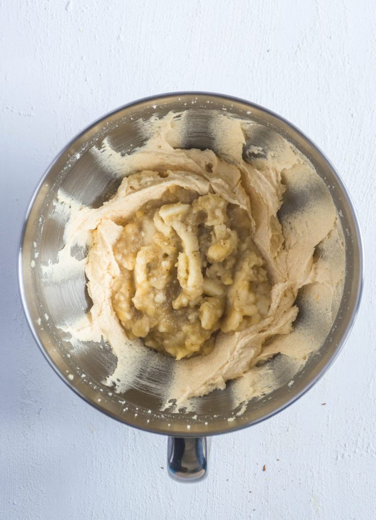 mashed bananas with whipped butter in mixing jar