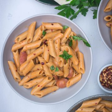 Penne in tomato vodka sauce in grey bowl