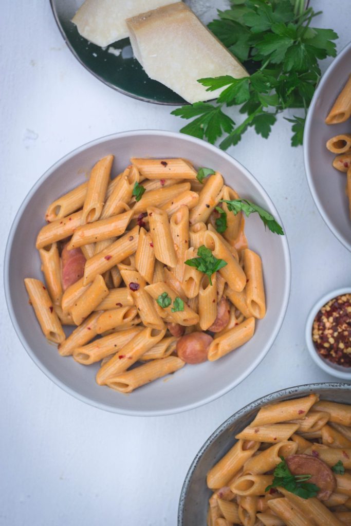 Penne in tomato vodka sauce in grey bowl