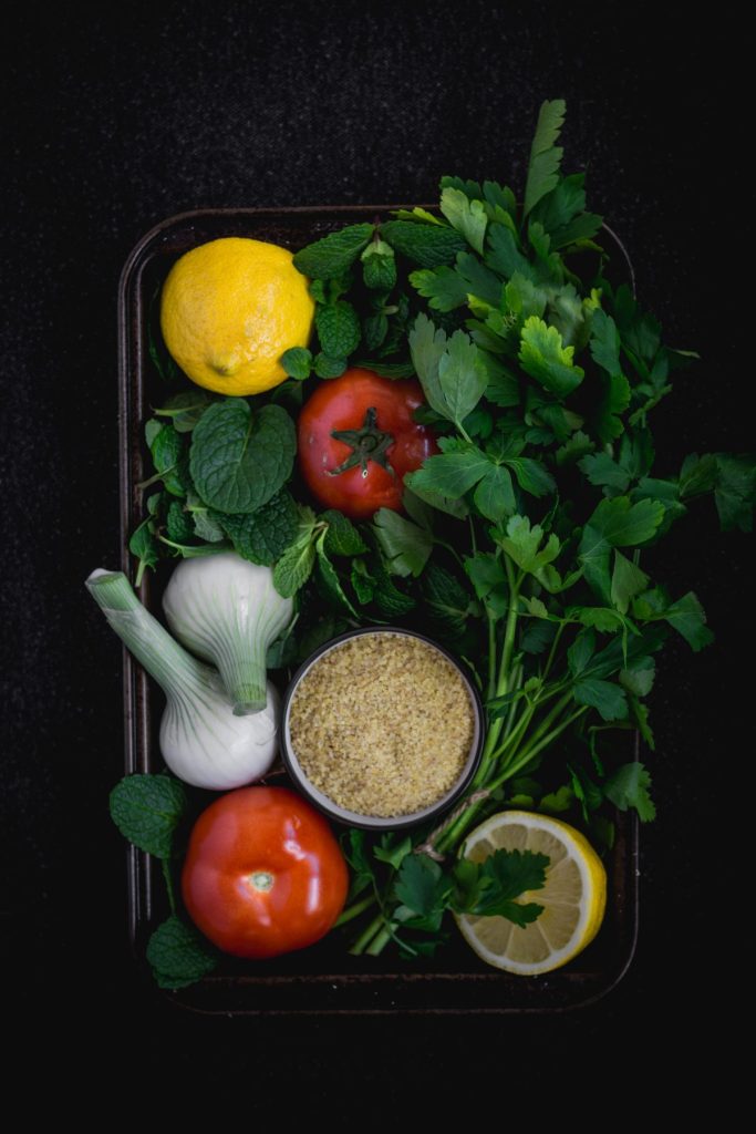 closeup of ingredients for tabbouleh in black tray