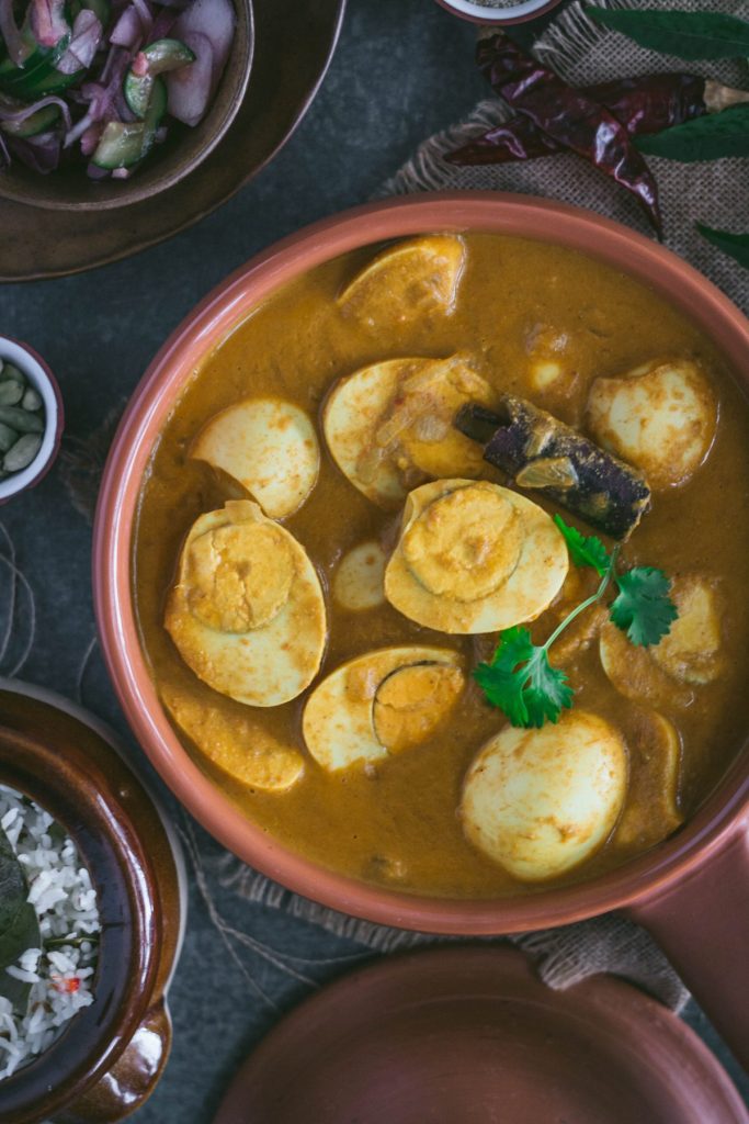 Indian style egg curry in terracotta bowl