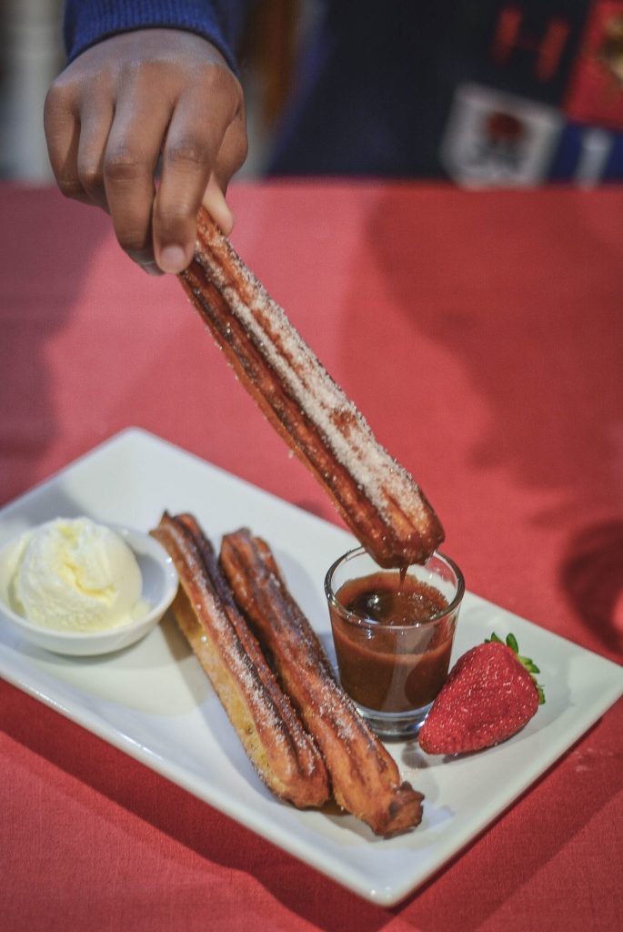 churros with chocolate dipping sauce with icecream and strawberry