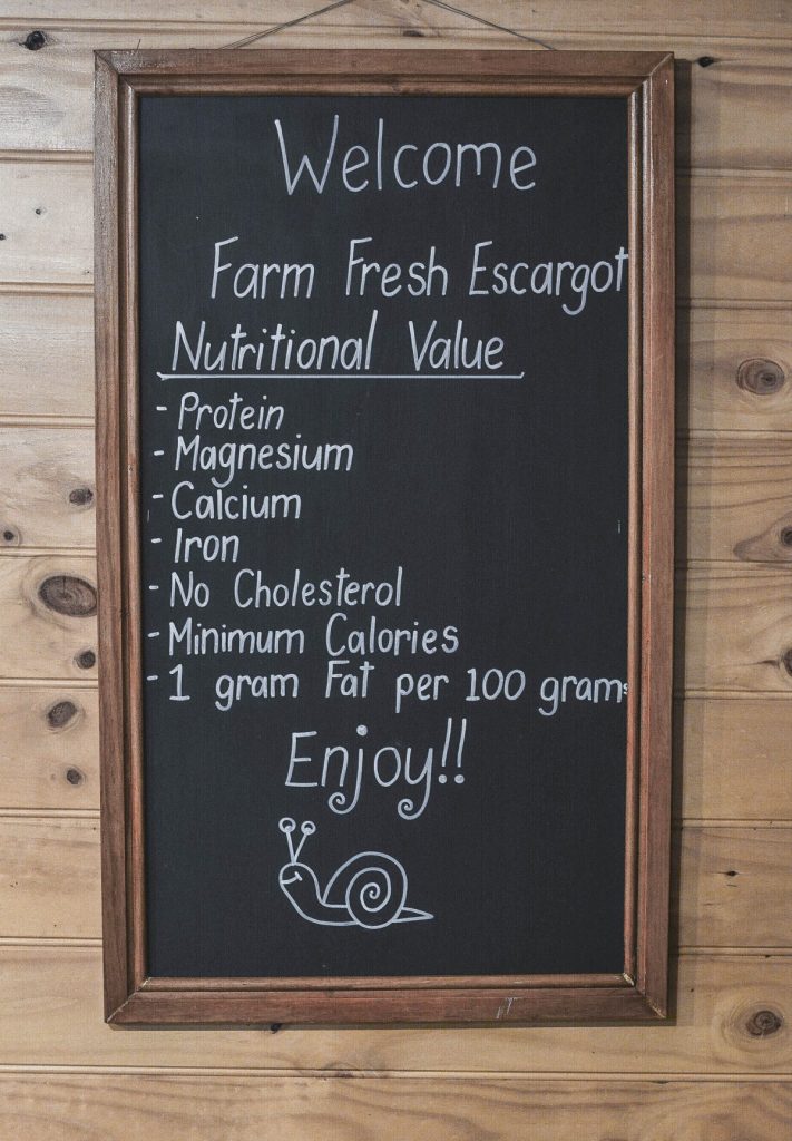 signboard with nutritional benefits of escargot in cafe