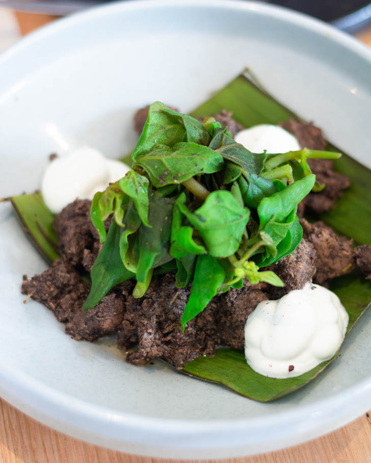 Wild boar with native lemongrass, pig’s blood, Warrigal greens, crispy nettles and labneh.