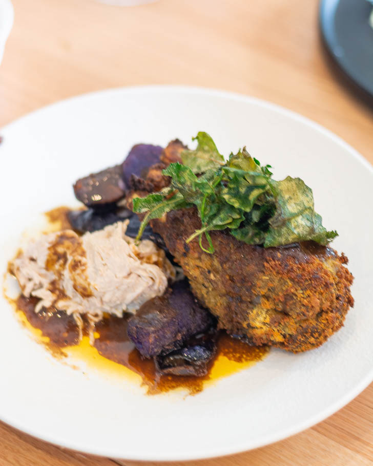 Saltbush and macadamia lamb rack, pepperberry bordelaise, pickled quandong, celeriac remoulade, crispy saltbush.