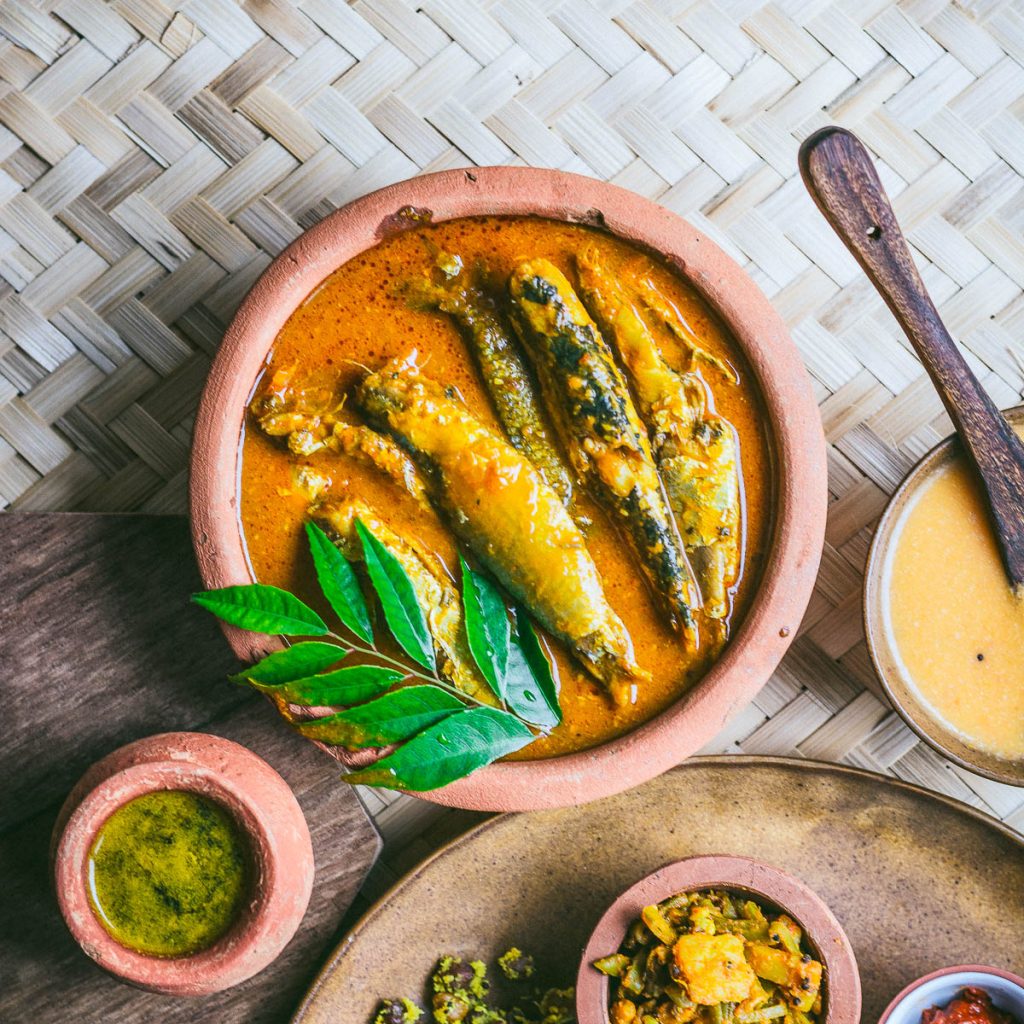 Sardine curry in a brown earthenware bowl