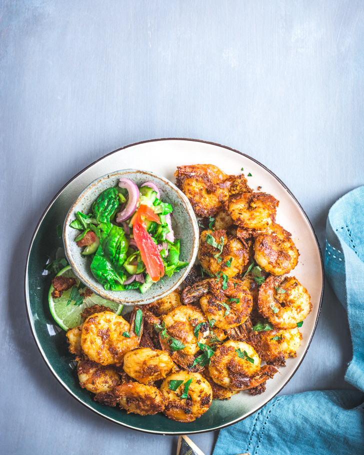 Prawns fry on a plate with a salad on the side