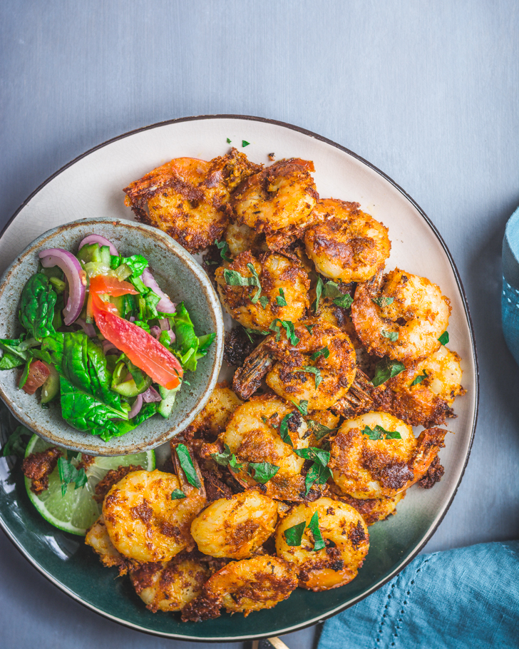 Prawns fry on a plate with a salad on the side