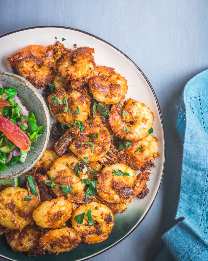 Prawns fry on a plate with a salad on the side