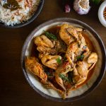 Quail curry served in grey bowl