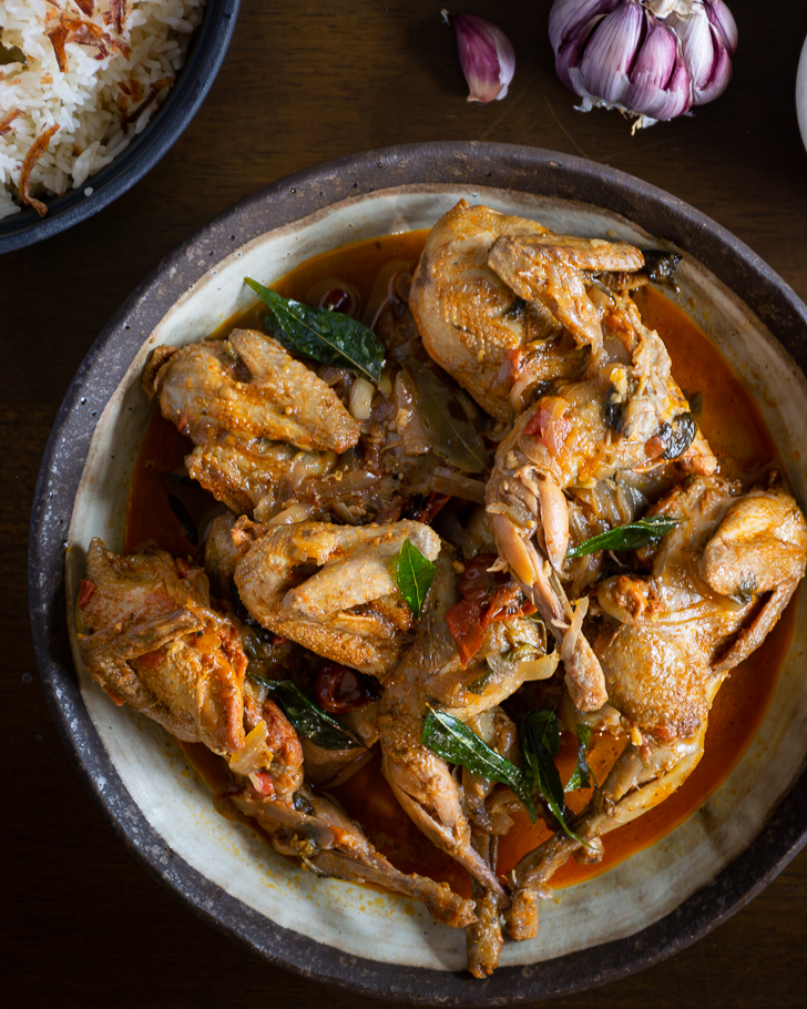 Quail curry served in grey bowl